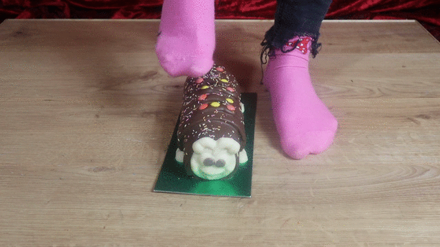 Crushing chocolate cake with bare feet